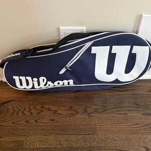 Wilsom tennis bag- navy never used. Holds 1 racquet.